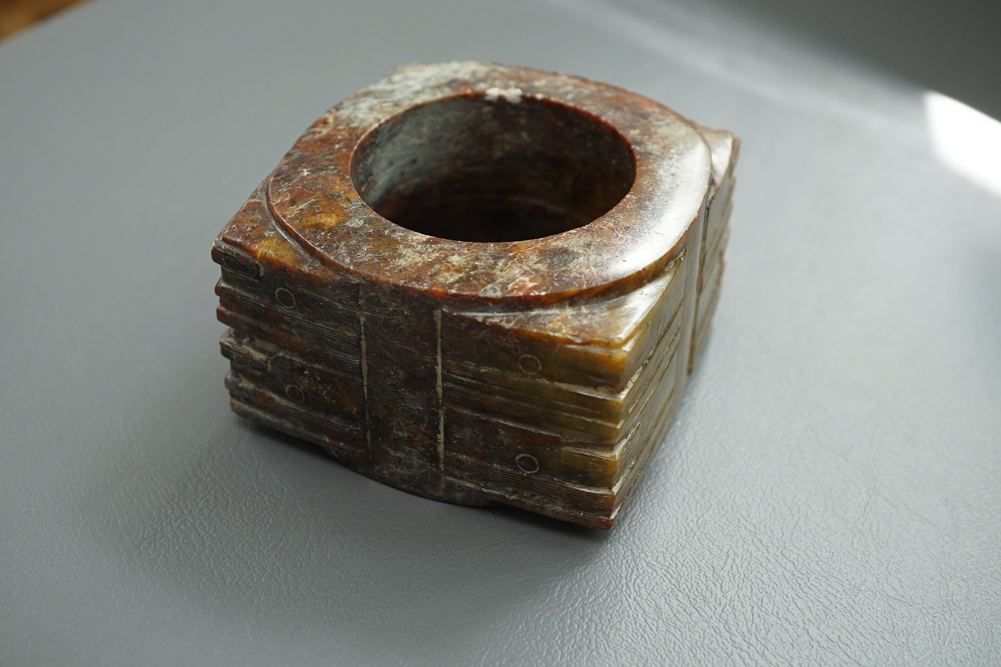 Four Chinese archaistic hardstone or burnt jade cong or cylinders